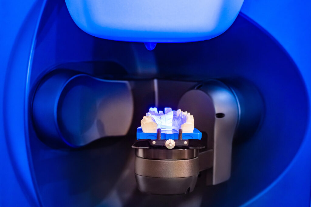 Dental laboratory. Production of dental crowns. Milling dental system with program control. Grinding and milling machine of dentures. Laboratory milling cutter for dental work. Dentistry.