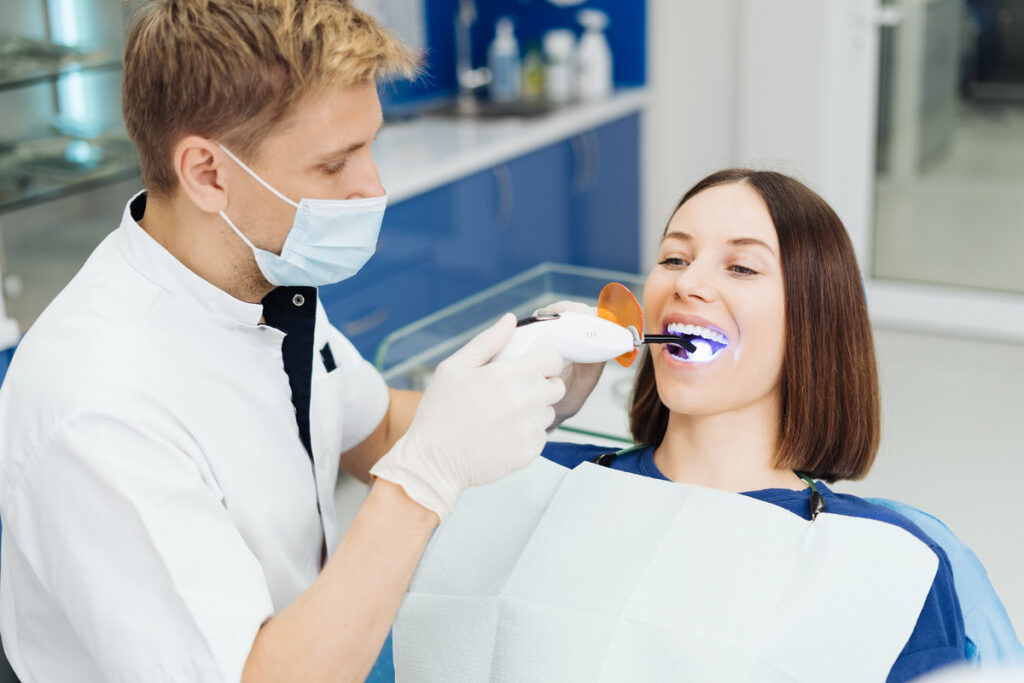 Close-up portrait of a female patient visiting dentist for teeth whitening in clinic