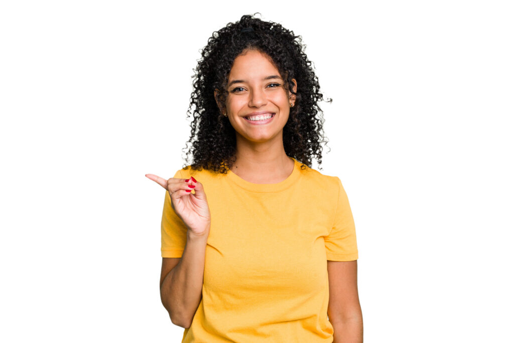 smiling cheerfully pointing with forefinger away.