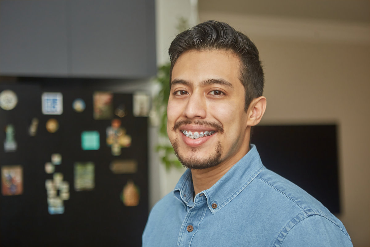 portrait of a hispanic young man with braces
