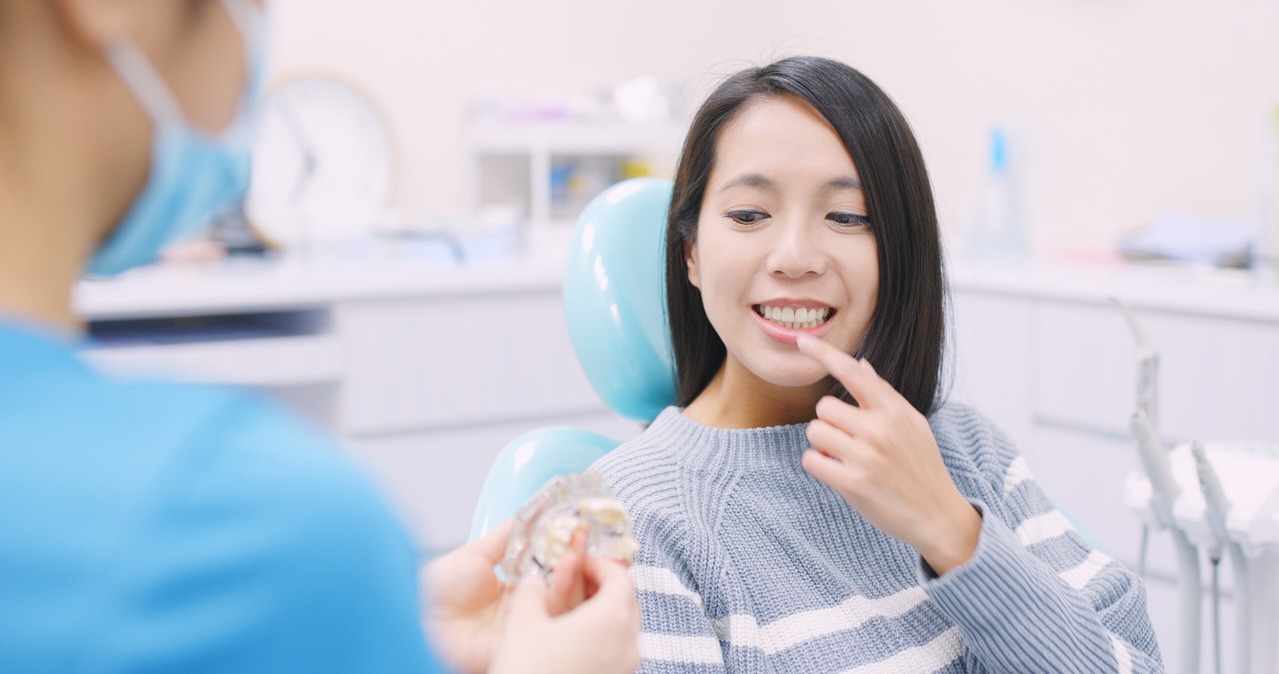 Dentist explaining the dental implant procedure to a patient