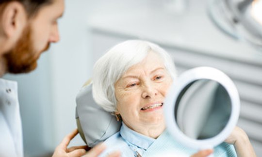 Smiling patient during a dental exam representing full mouth reconstruction care at Ponce Dental Studio