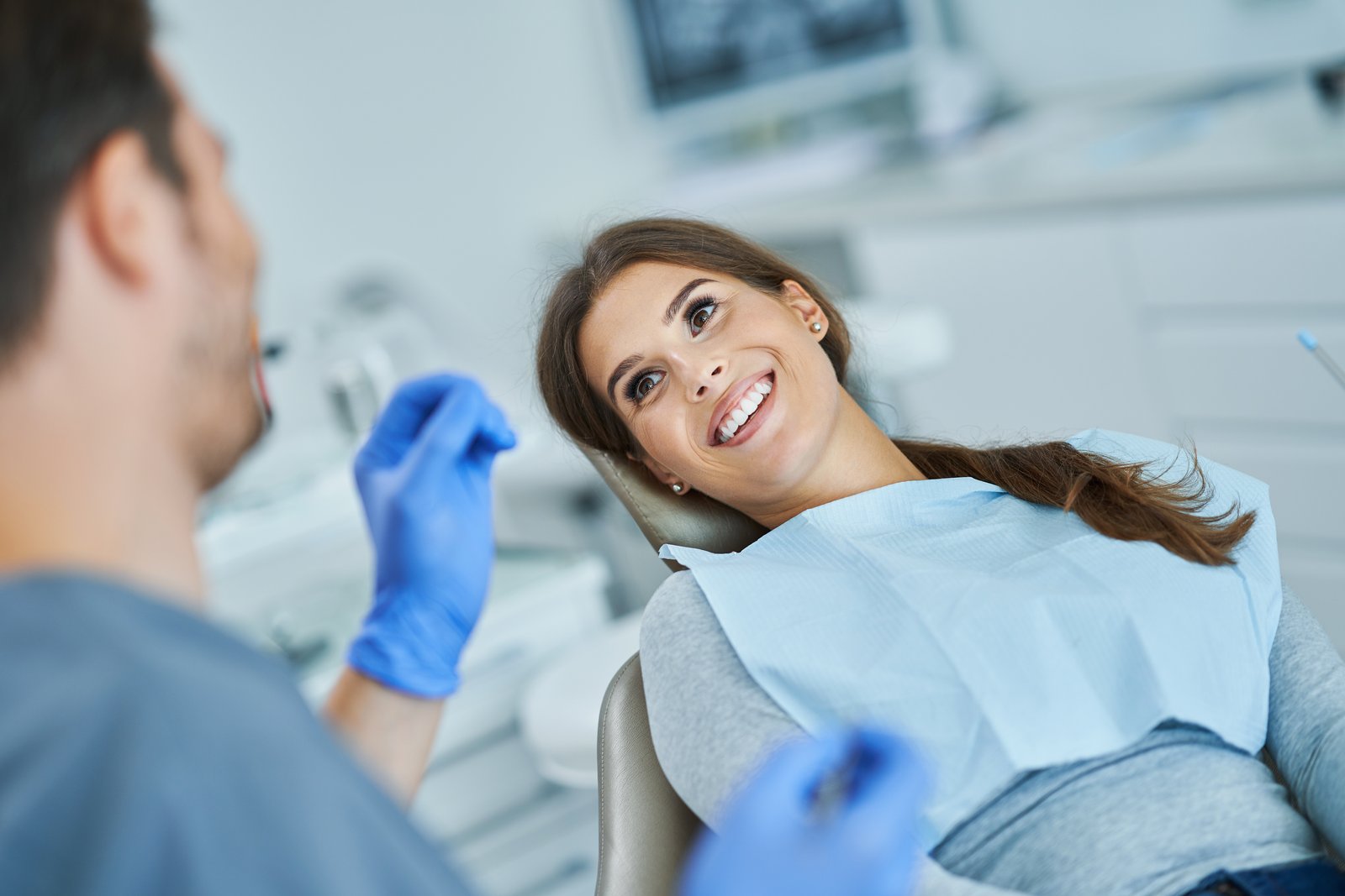 Adult patient receiving a dental sealant treatment at the dentist