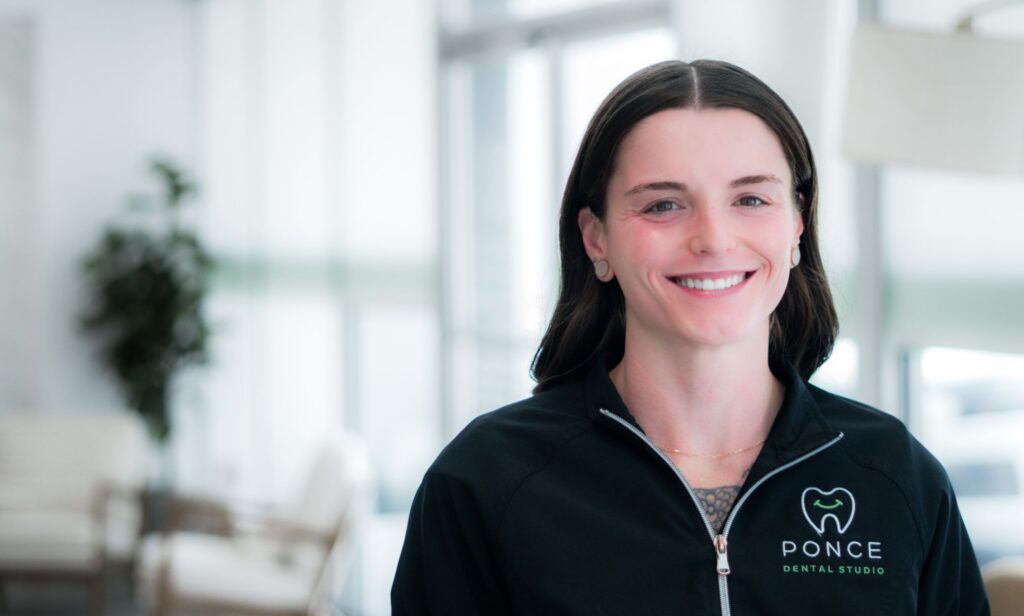 Jennie, Ponce Dental Studio team member, smiling in modern dental office