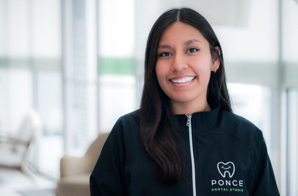 Naomi, Ponce Dental Studio team member, smiling in modern dental office