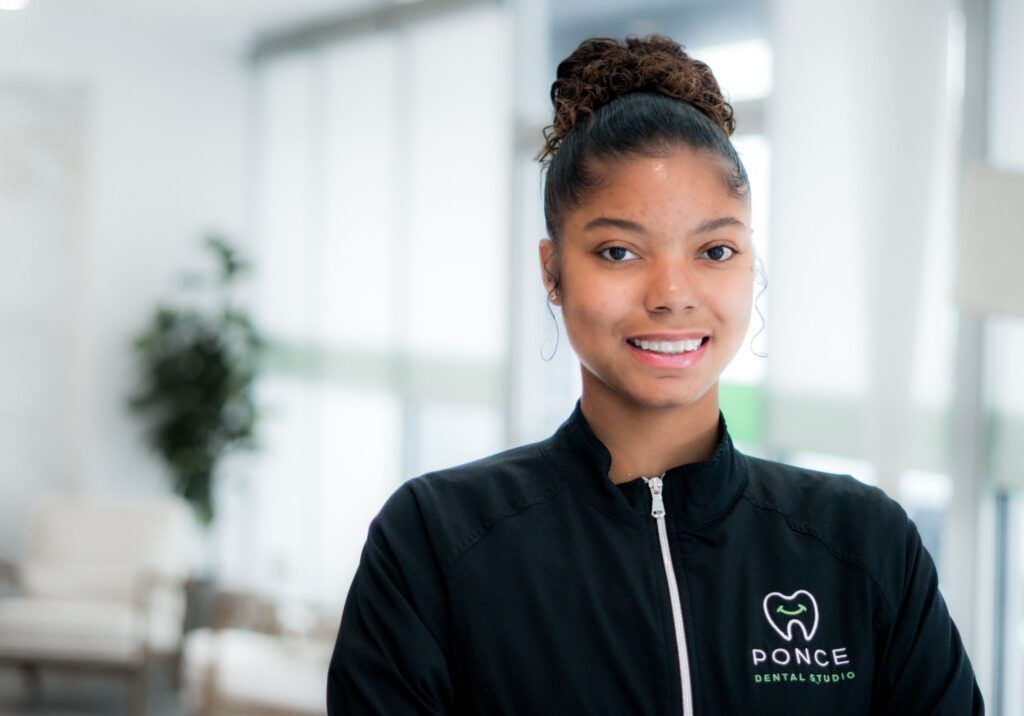 Nia, Ponce Dental Studio dental professional, smiling in office setting