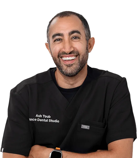 Ash Toub from Ponce Dental Studio, male dental professional in black scrubs, smiling